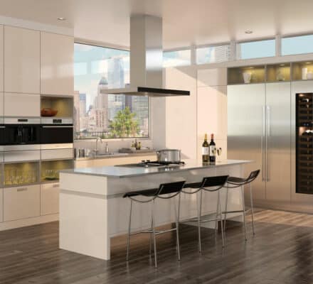 Modern kitchen with an island, three bar stools, premium Wolf appliances, a wine fridge, and large windows overlooking a cityscape—perfect for those seeking a luxury kitchen appliance experience.