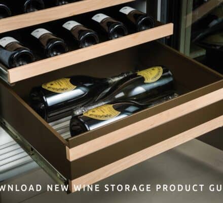 Open wine storage drawers filled with wine bottles, featuring wooden trim and metal slides in an appliance showroom, with a text overlay promoting a wine storage product guide download.