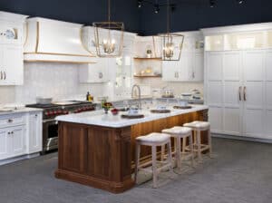 Kitchen with white cabinetry, marble countertops, and a wooden island - perfect for those looking to buy Sub-Zero appliances.