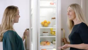 A Clarke consultant shows off a refrigerator and explains why she should buy Sub-Zero appliances for even fresher storage.