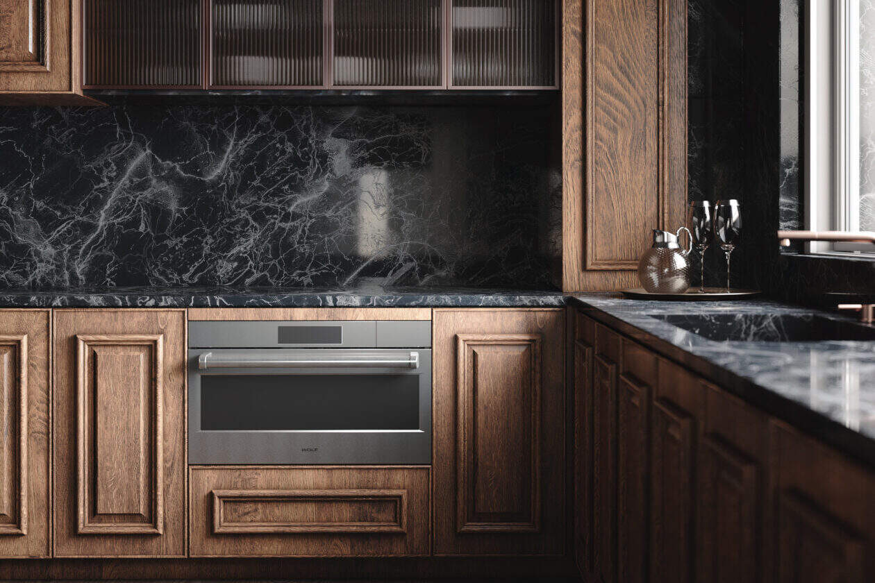 Modern kitchen with dark wood cabinets, black marble countertops and backsplash, a built-in steam convection oven, and glass-front upper cabinets next to a large window.