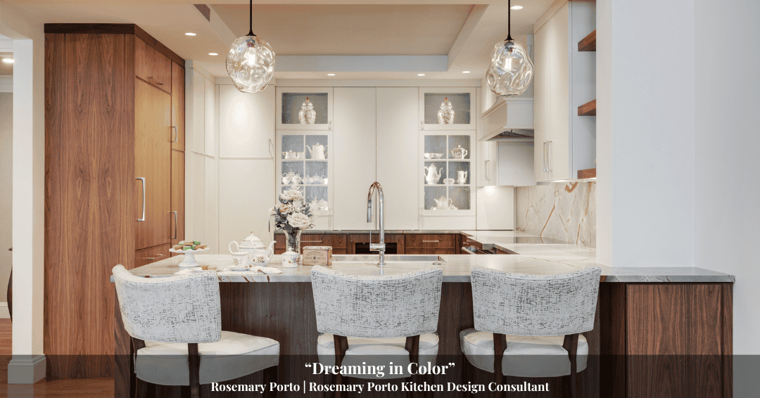 Modern kitchen with white cabinets, marble countertops, wooden accents, and three upholstered barstools—blending sleek design with subtle touches inspired by Clarke History. Decorative items are displayed on the island and shelves.